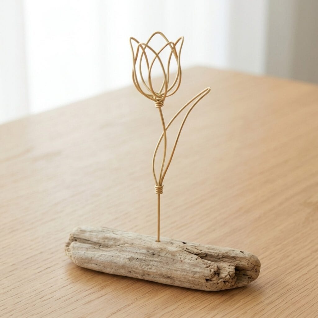 Minimalist brass tulips displayed as elegant wire flower crafts on driftwood