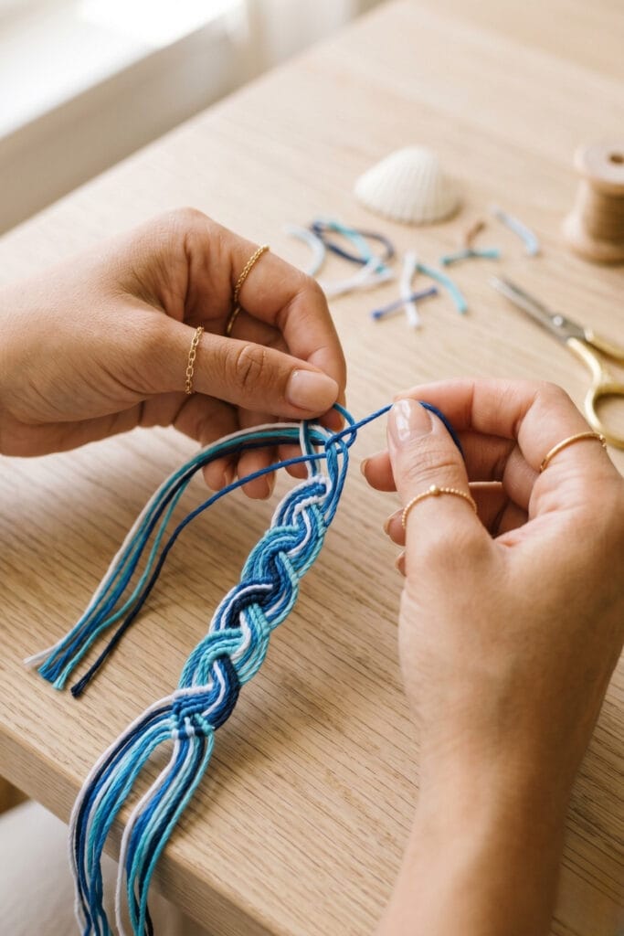 Blue and white threads woven into an ocean wave pattern for DIY bracelets with string.