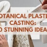 A blog featured image titled "Botanical Plaster Casting: 10 Stunning Ideas." The layout shows a curated collage of handmade white plaster projects, including an angled wheat cylinder weight, a fern-frond incense boat, a bas-relief bookmark, and a minimalist intaglio sprig block. Manicured hands are shown interacting with the tactile, chalky plaster surfaces against a bright, clean studio backdrop.