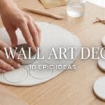 The manicured hands of a young woman making minimalist matte clay disc DIY wall art decor with blog post title overlay