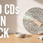 A beautifully finished flat CD upcycling craft leaning on a desk with typography reading OLD CDs SPIN BACK.